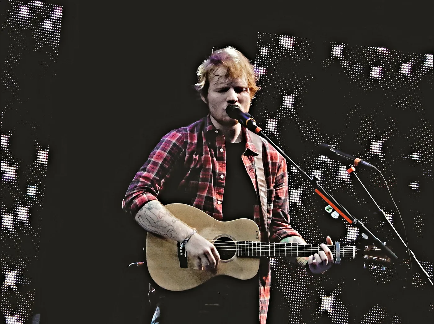 Ed Sheeran singing with a guitar at V Festival