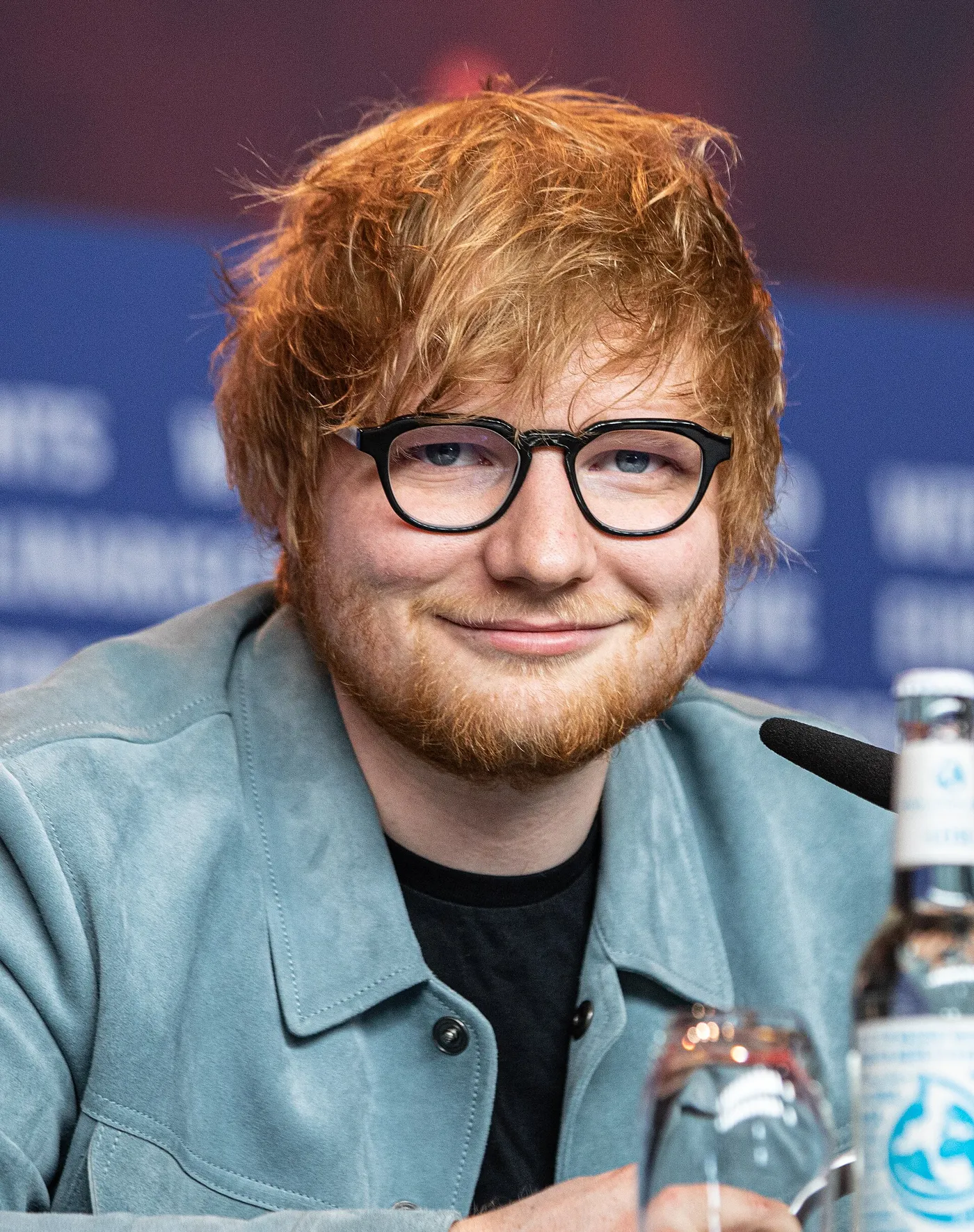 Ed Sheeran smiling at a press conference